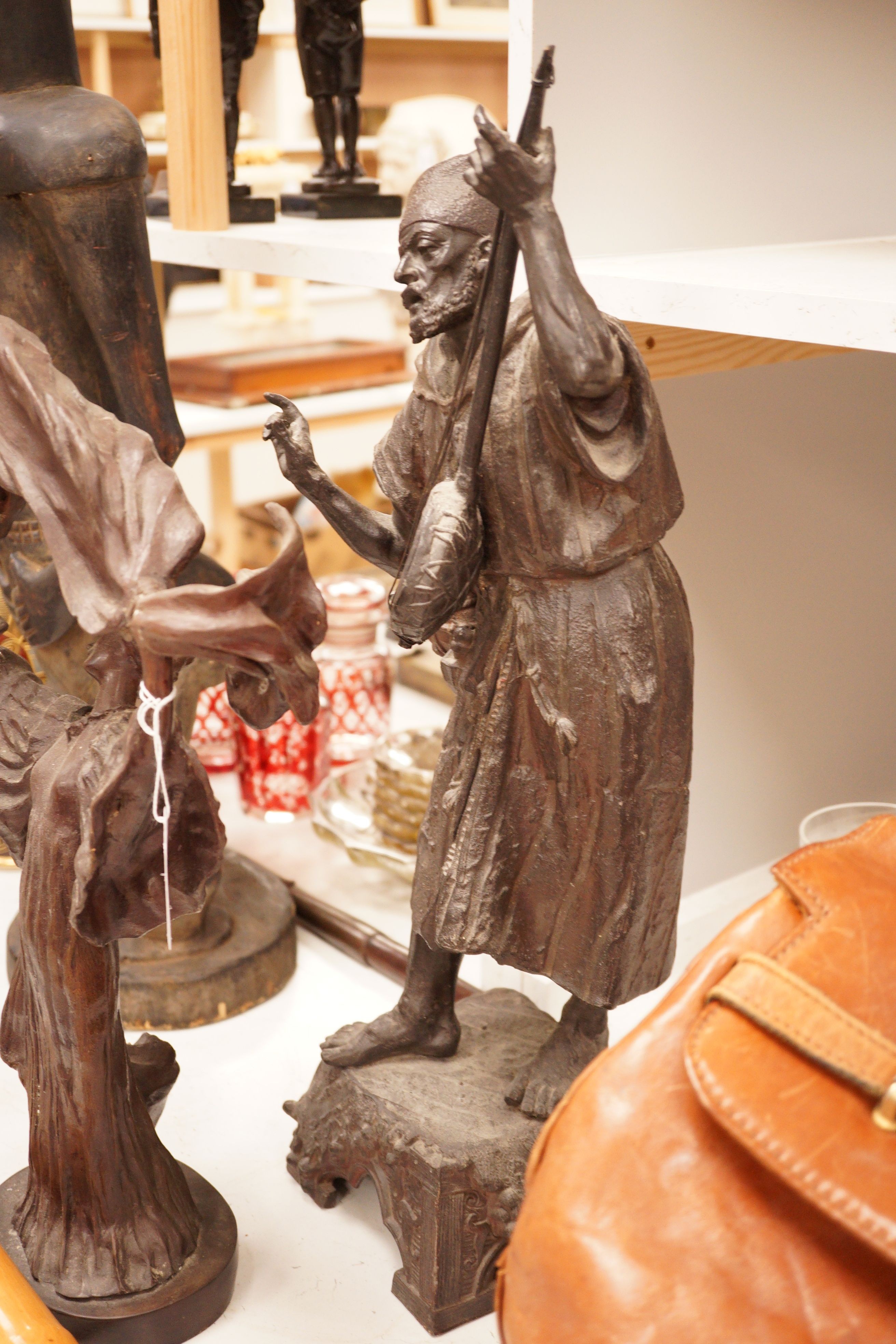 A large spelter figure of an eastern musician together with a bronze of a lady, tallest 58cm